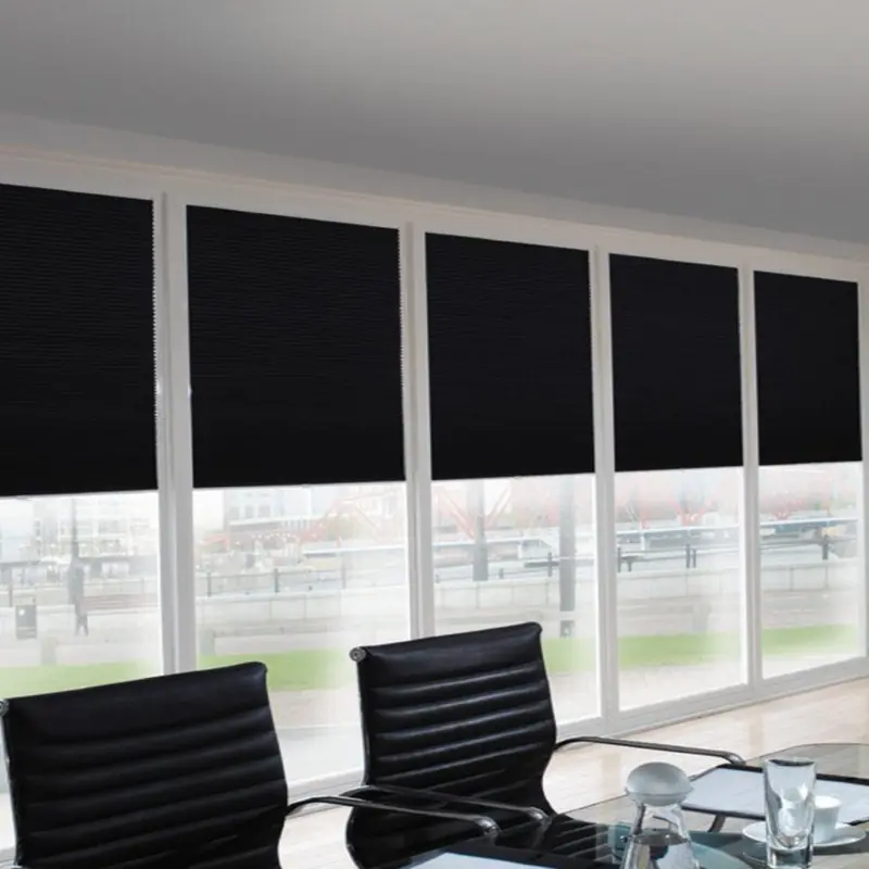 Black pleated office blinds in a modern corporate office space.