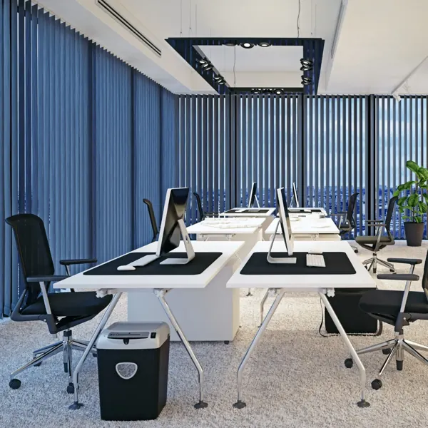 Blue vertical blinds installed in a modern open-plan office workstation