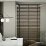 Brown faux-leather Venetian blinds in a modern room.