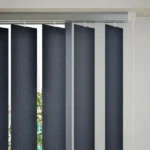 Close-up of charcoal vertical blind slats and track.