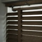 Close-up of dark brown textured slats and decorative tape.