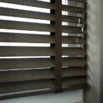 Detail of cracked leather texture on Venetian blind slats.