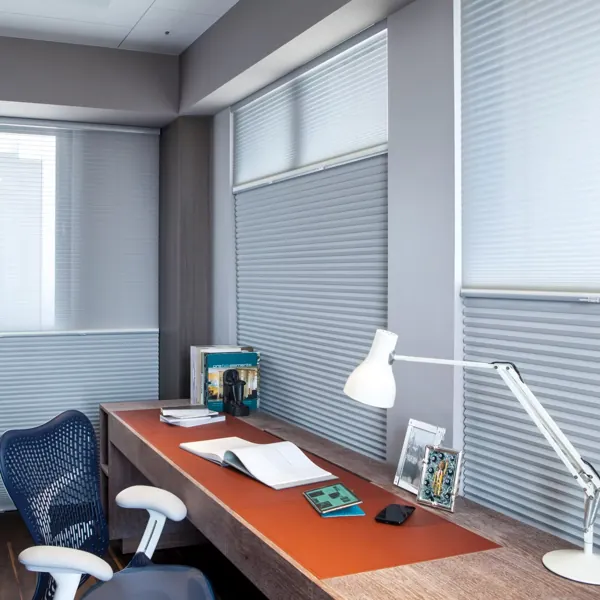 Grey roller blinds in a sleek, modern office.