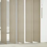 Macro view of textured fabric on vertical blind slats.
