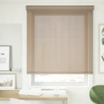 Neutral sunscreen roller blind in a modern home office