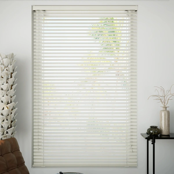 Off-white Venetian blinds on a bright window.
