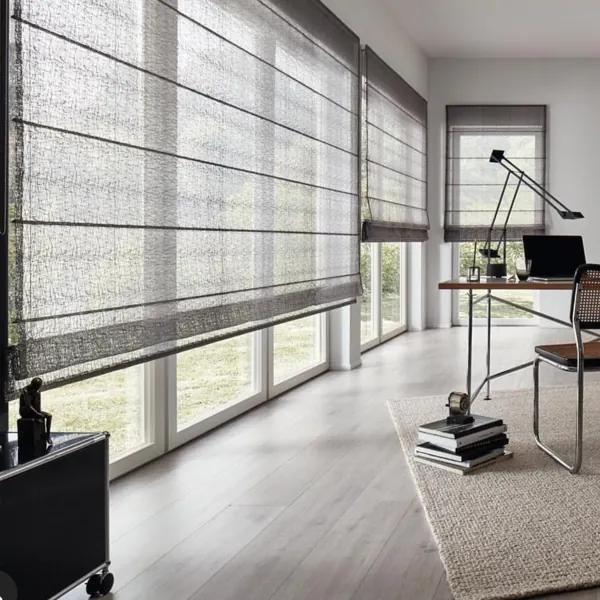 Sheer grey roman blinds in a bright, modern home office.