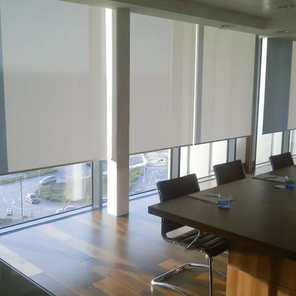 White motorized roller blinds installed in a modern executive boardroom