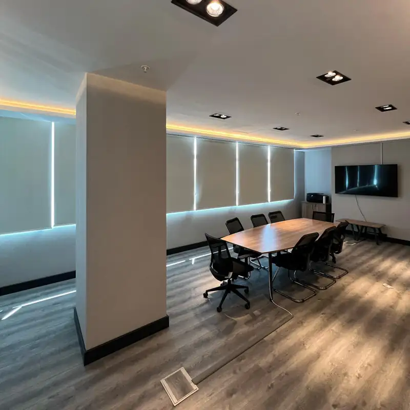 White roller blinds in a professional office meeting room.