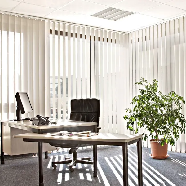 White vertical blinds in a bright, modern office.